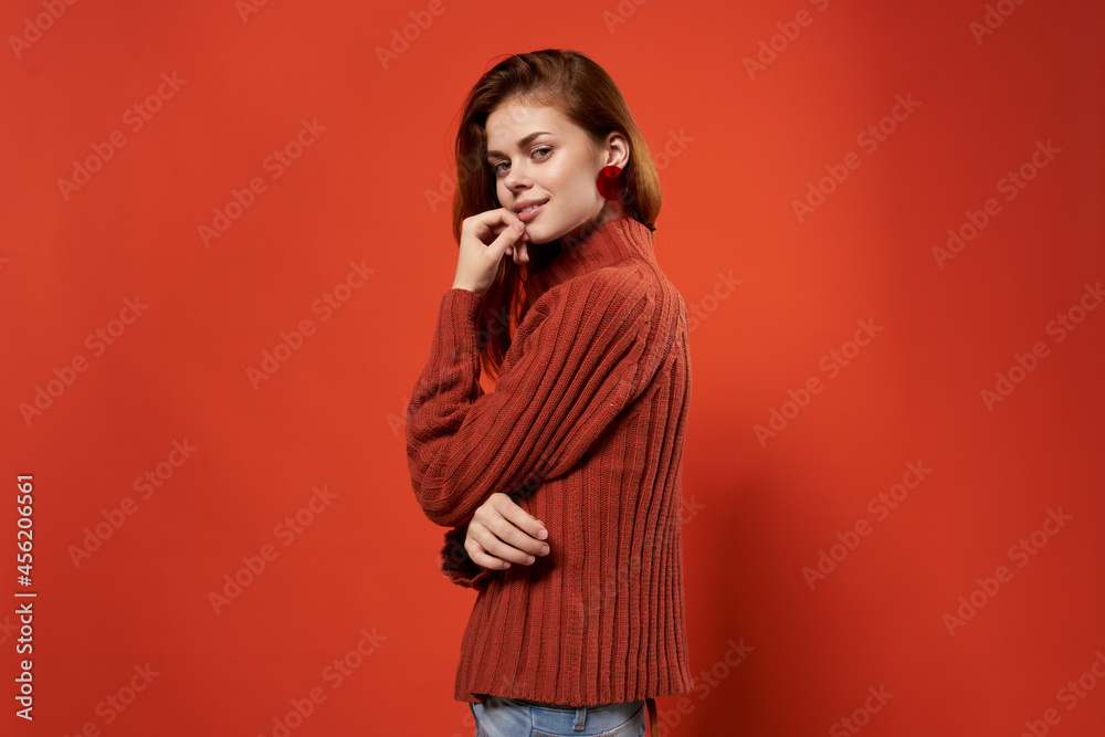 cheerful woman in a red sweater makeup earrings fashion studio cheerful woman in a red sweater makeup earrings fashion studio