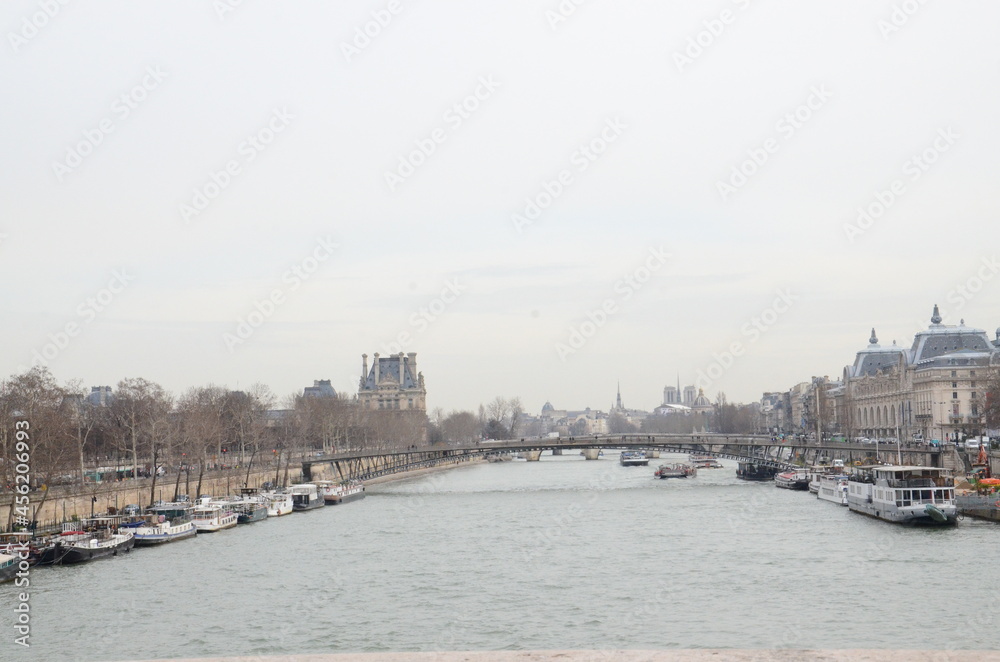 Sighseeing cruises docked on the sides of  famous Seine River in Paris, France.