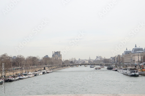 Sighseeing cruises docked on the sides of famous Seine River in Paris, France.