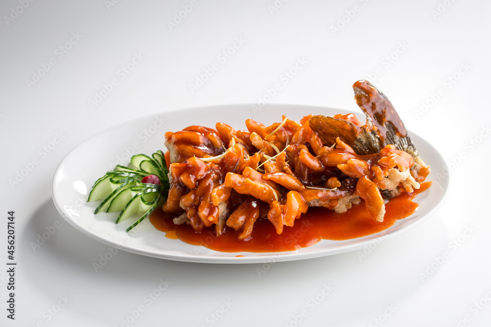 whole carp fish in sweet and sour sauce chinese cuisine isolated on white background whole carp fish in sweet and sour sauce chinese cuisine isolated on white background