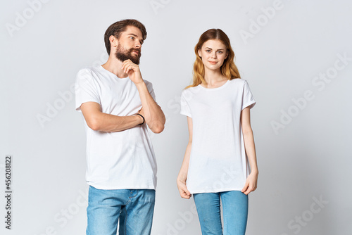 man and woman in white t-shirts studio fashion posing fun light background