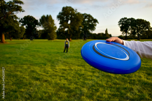 Closeup of a Frisbee in the hand before the throw in a game in the park