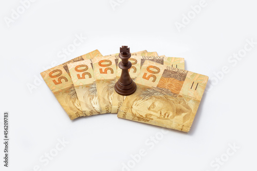 Piece of chess of 50 reais. Brazilian money concept photo