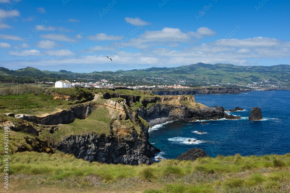 Panoramic view of Northern coast of Sao Miguel Island (Azores, Portugal) close to Fenais da Luz with the Hermitage of Saint Peter, or Ermida de Sao Pedro, on a sunny day