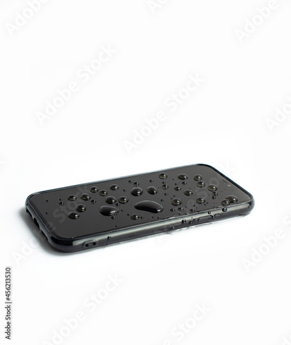 A wet black smartphone in white background