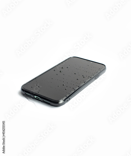 A wet black smartphone in white background