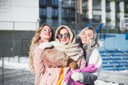 Three beautiful Russian girls are having fun on the street