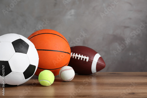 Set of different sport balls on wooden surface. Space for text