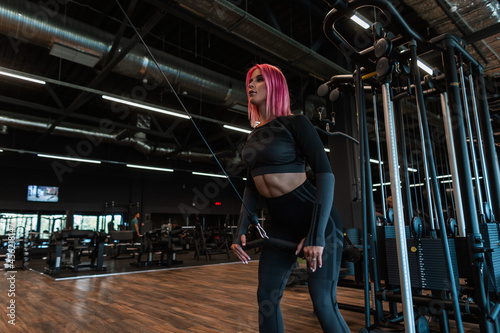 Fitness woman in stylish black sportswear working out in the gym © alones