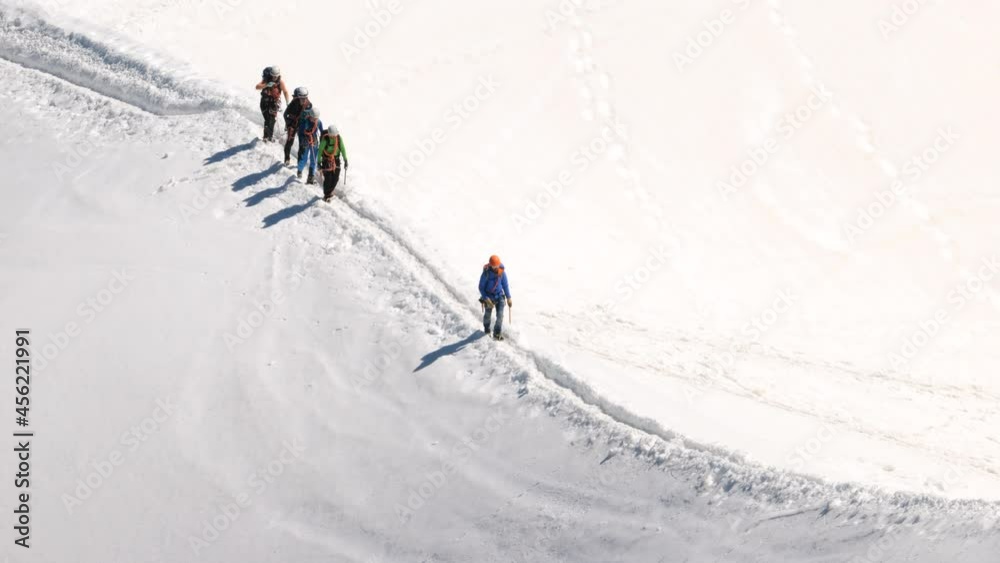 alpinists climbing mountain in good sunny conditions alpinists climbing mountain in good sunny conditions