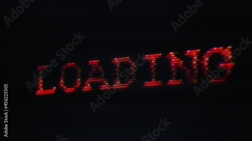 Loading distorted glitchy red text on vintage screen display - retro gaming, 80s and 90s vhs nostalgia concept