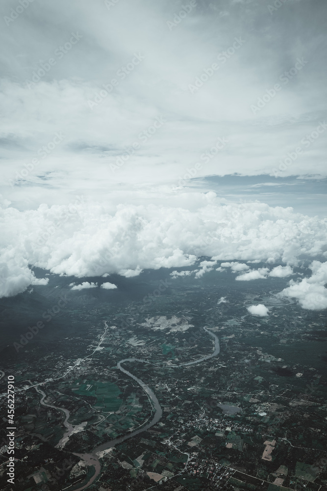 Aerial view over Chiang mai , Thailand of river on land and puffy cloud in the sky , calm and mindfulness concept