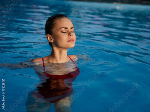 woman in swimsuit swim in the pool luxury enjoyment vacation