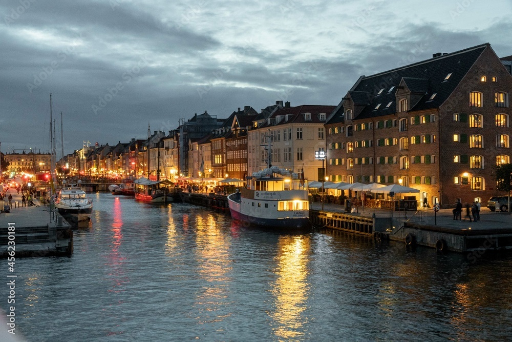 Copenhague, Denmark. September 28, 2019: Nyhavn promenade with colorful architecture and boats on the canal.