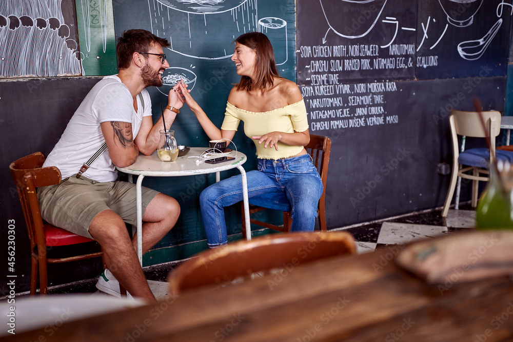 Urban couple having a drink in a cafe; Casual lifestyle concept