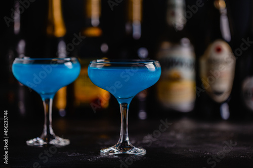 Blue cocktail / wine / champagne on a dark table