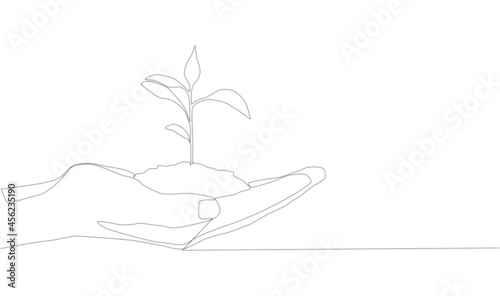 continuous line drawing of hand showing growing plant