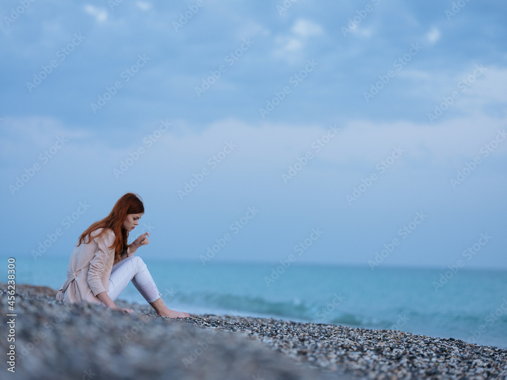 woman sitting on the shore beach ocean landscape fresh air woman sitting on the shore beach ocean landscape fresh air