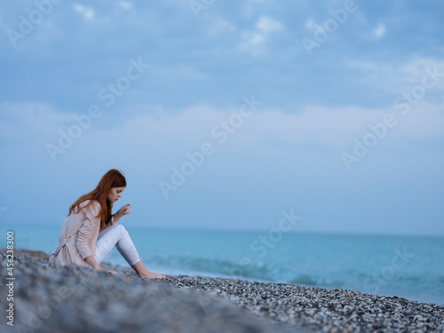 woman sitting on the shore beach ocean landscape fresh air