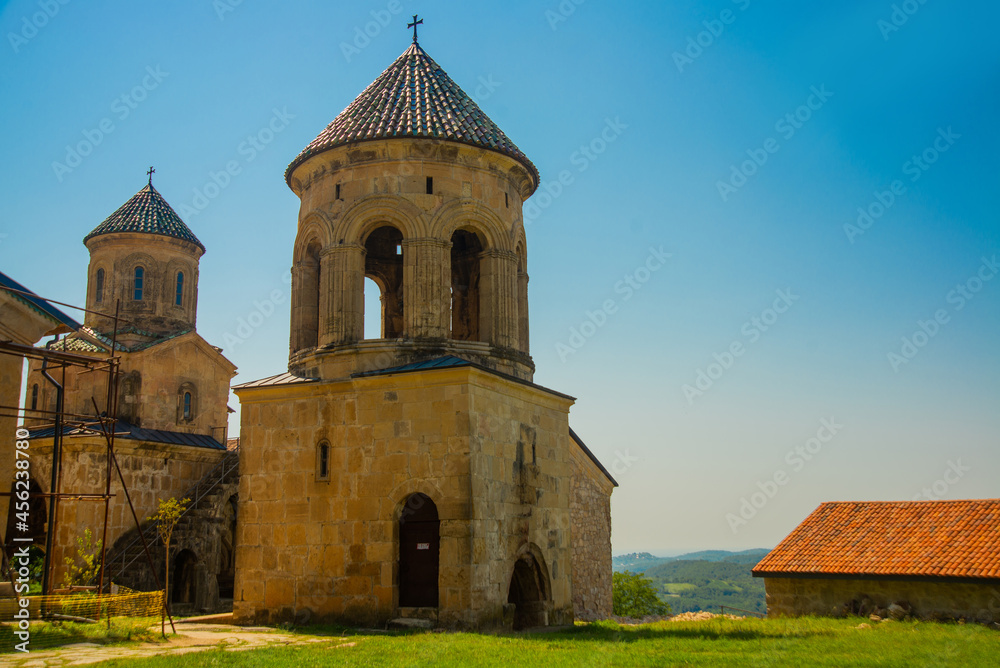 KUTAISI, GEORGIA: View of the old stone Bell Tower in the Orthodox monastery of Gelati on a sunny summer day. UNESCO.