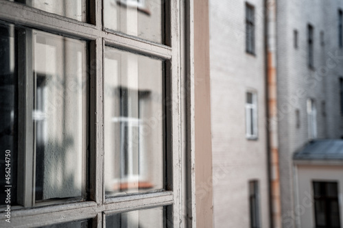 Wooden vintage white window frame and house outside the window on blur  997 