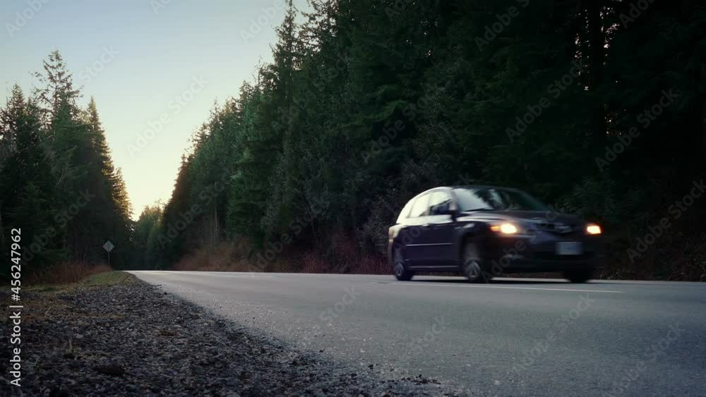 Car Passes On Rural Highway At Dusk Car Passes On Rural Highway At Dusk