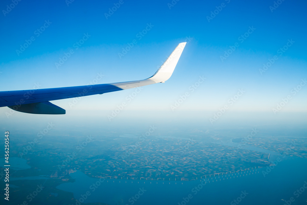 Amsterdam, Netherlands - 17 July 2021: KLM Plain wing over Holland. Flight from Amsterdam to Helsinki. Amsterdam, Netherlands - 17 July 2021: KLM Plain wing over Holland. Flight from Amsterdam to Helsinki.