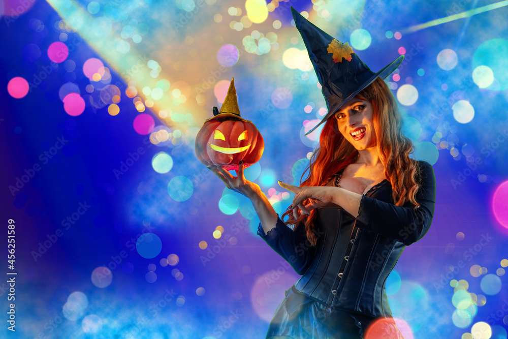 Halloween Witch Woman with long red hair and holiday make-up wearing dark tapered witch's hat Halloween Witch Woman with long red hair and holiday make-up wearing dark tapered witch's hat