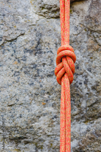 eight rope knot on rocky background