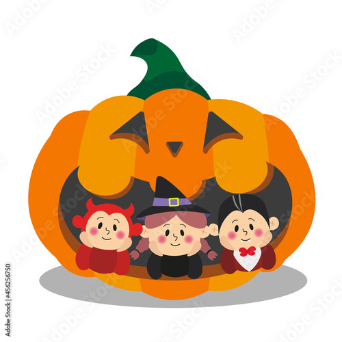 Children in Halloween costumes in a huge pumpkin