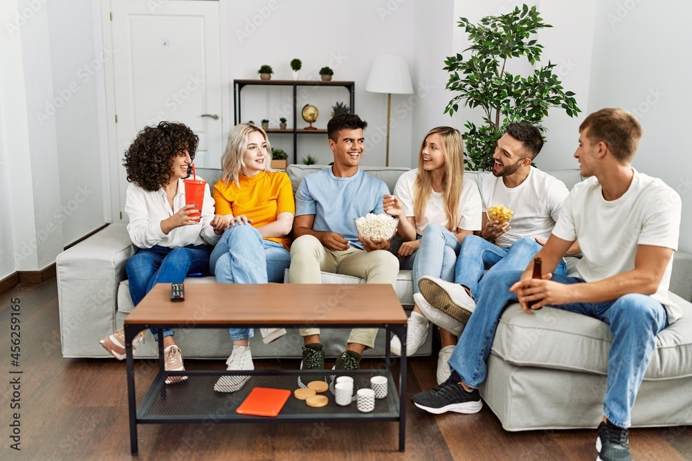 Group of young friends smiling happy watching movie at home. Group of young friends smiling happy watching movie at home.