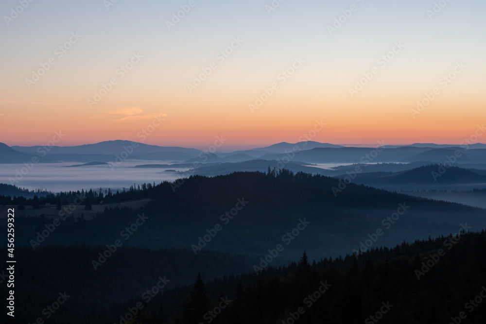 a beautiful landscape with hills and valleys in the morning