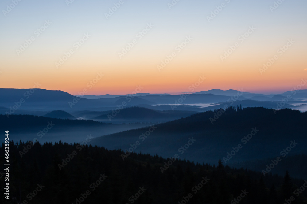 landscape with mountains and fog in the valleys in the morning landscape with mountains and fog in the valleys in the morning