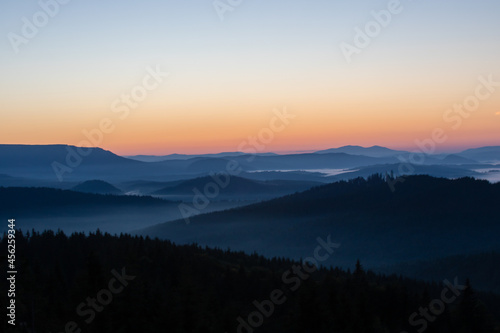 landscape with mountains and fog in the valleys in the morning