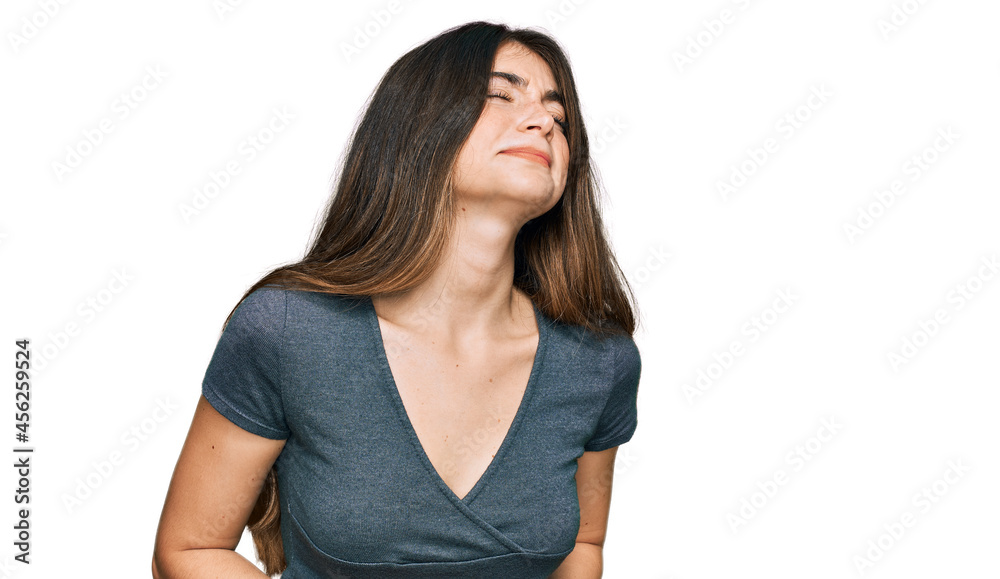 Young beautiful teen girl wearing casual crop top t shirt with hand on stomach because nausea, painful disease feeling unwell. ache concept. Young beautiful teen girl wearing casual crop top t shirt with hand on stomach because nausea, painful disease feeling unwell. ache concept.