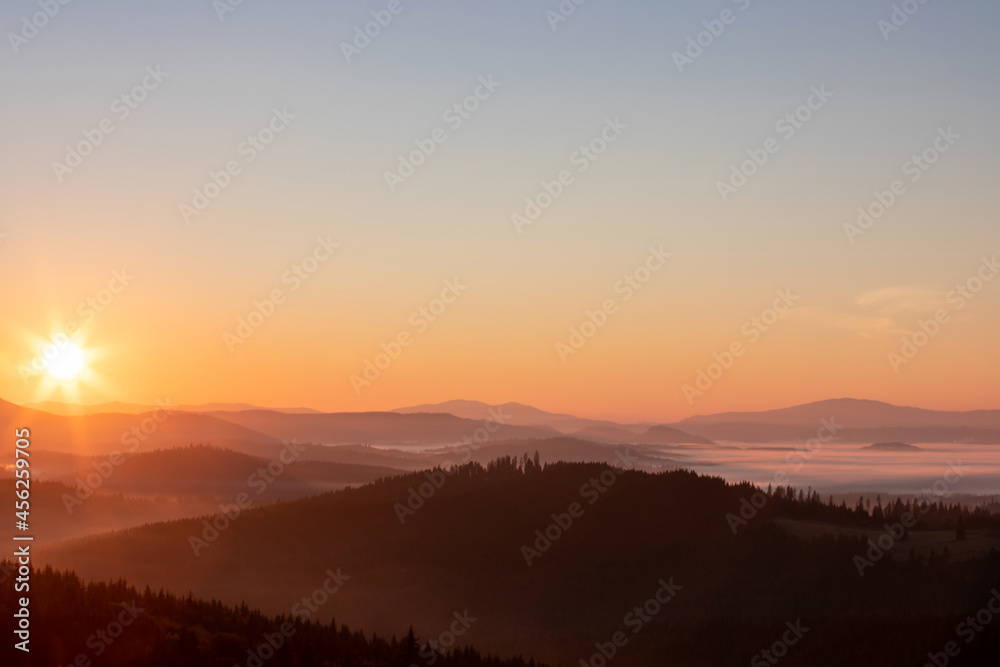 a beautiful landscape with a sunrise over the mountains