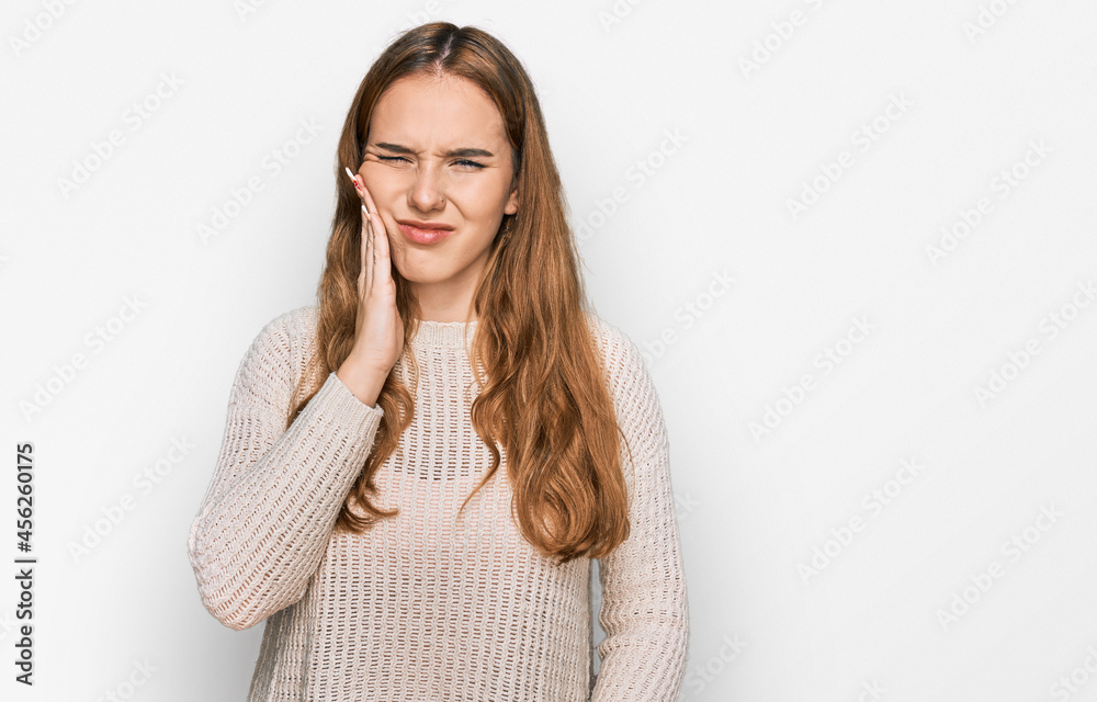 Young blonde woman wearing casual clothes touching mouth with hand with painful expression because of toothache or dental illness on teeth. dentist