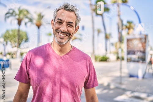 Middle age hispanic man smiling confident at street