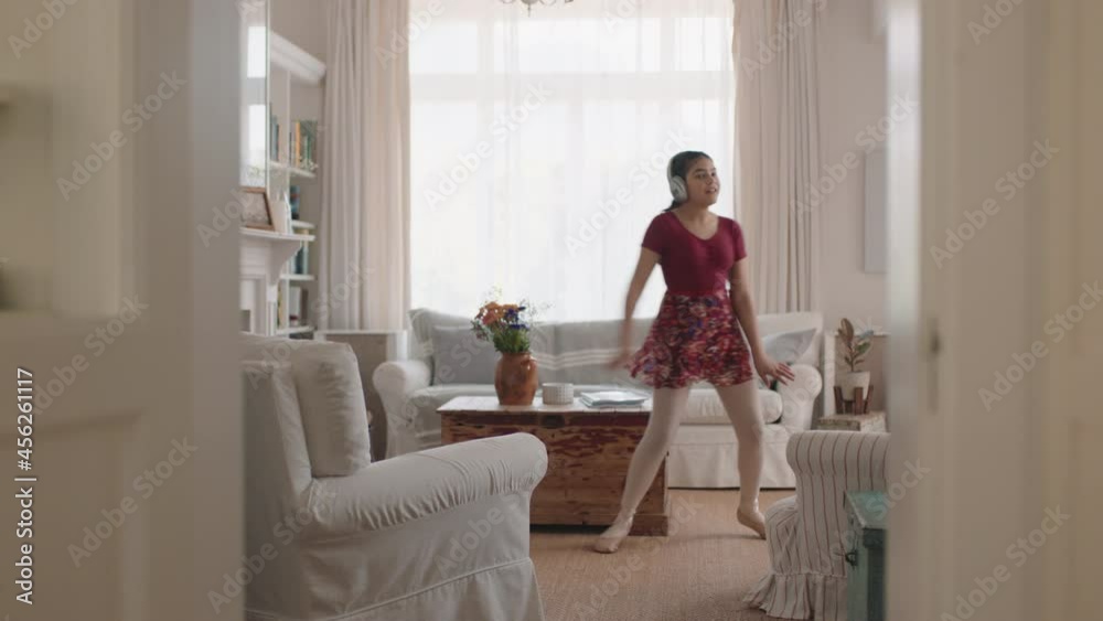 happy teenage girl dancing practicing ballet dance moves at home listening to music wearing headphones having fun enjoying weekend happy teenage girl dancing practicing ballet dance moves at home listening to music wearing headphones having fun enjoying weekend