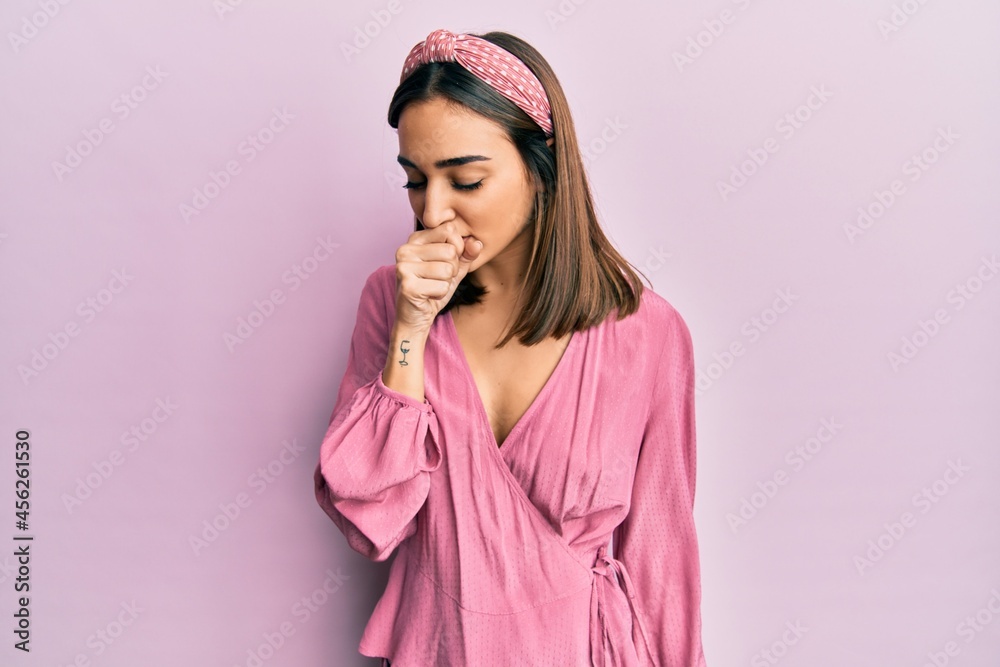 Young brunette girl wearing casual clothes feeling unwell and coughing as symptom for cold or bronchitis. health care concept.