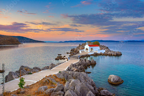 фотографія Little church of Agios Isidoros in the sea over the rocks, Chios island, Greece