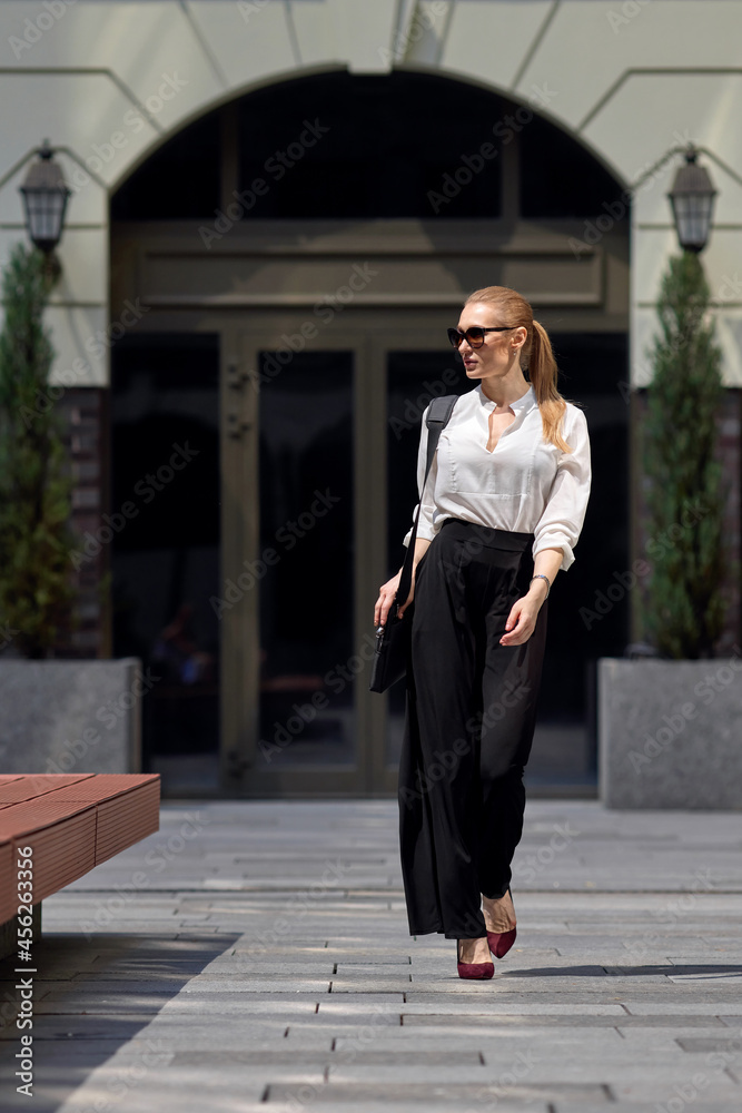 beautiful woman in sunglasses in the street beautiful woman in sunglasses in the street