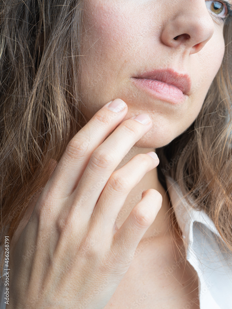 Model, brunette close-up. in a studio. She is wearing a white shirt, a black hairstyle.