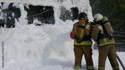 Firefighters extinguish the fire with foam