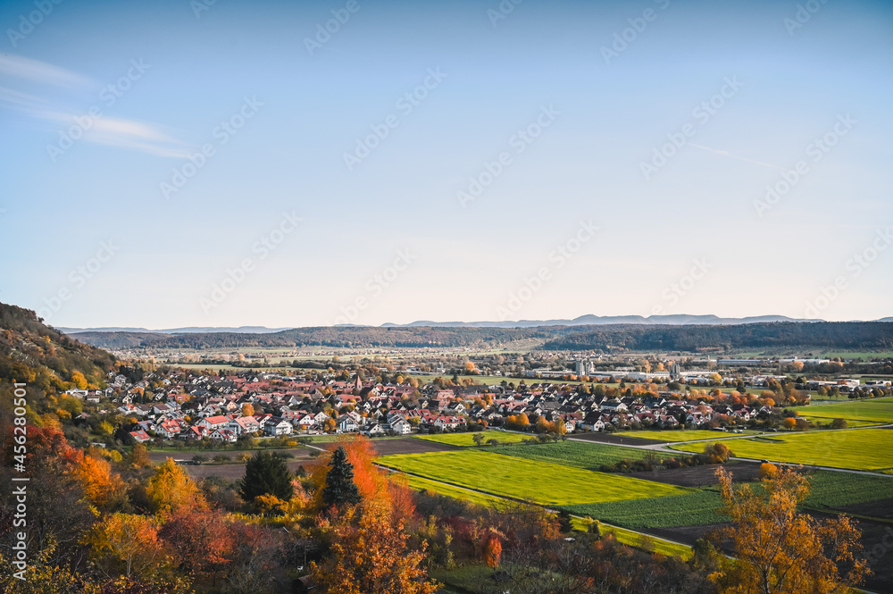 Scenic autumnal view of the Neckar valley and the village of Hirschau, Germany during dawn.