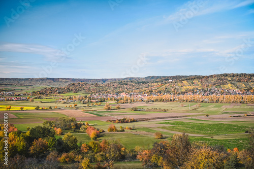 Panoramic view of an autumnal countryside  colorful meadows and trees  fields and forested hills of the Sch  nbuch natural reserve in the background.