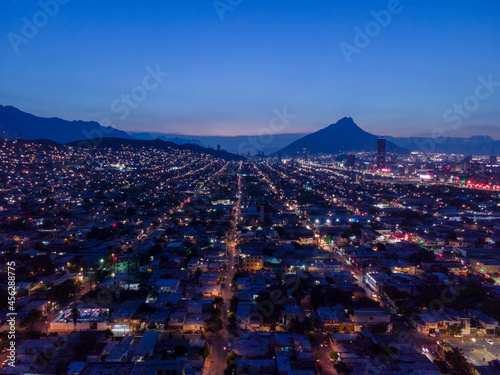 illuminated streets of a city with a sunset in the background