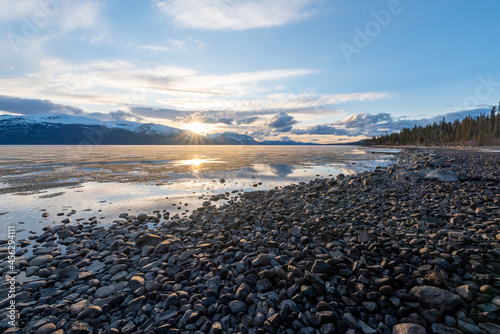 Rocky lakeshore sunset in Atlin, British Columbia during spring time.  photo