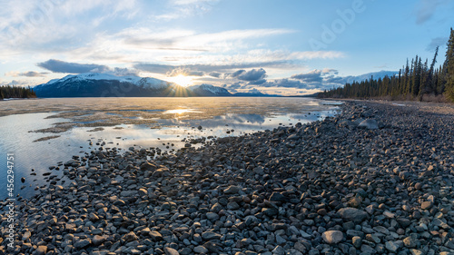 Rocky lakeshore sunset in Atlin, British Columbia during spring time. 