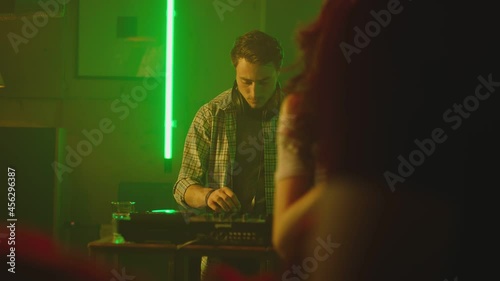 Wallpaper Mural Young people dancing inside night club . Dj playing music .  Dj Mixer Controller Desk in Nightclub Disco Party. DJ Hands touching Buttons and Sliders Playing Electronic Music . Girls and boys dancing Torontodigital.ca